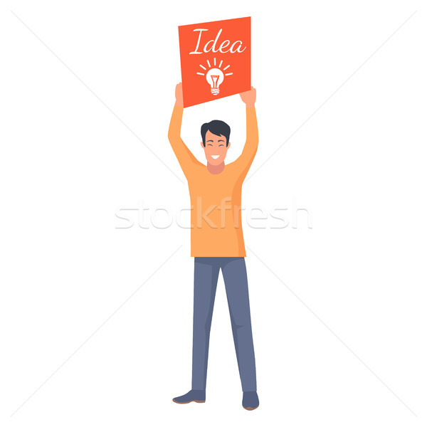 Smiling Male Holding Orange Card with New Idea Stock photo © robuart