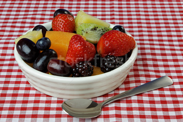 Tál gyümölcsöstál gyümölcs piros asztalterítő kanál Stock fotó © rogerashford