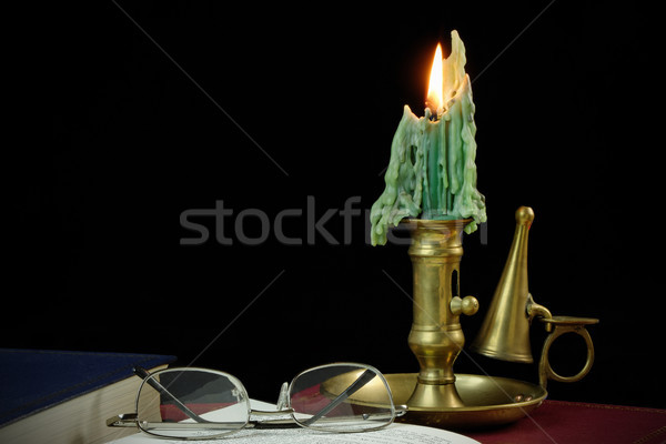 Reading by candle light Stock photo © rogerashford
