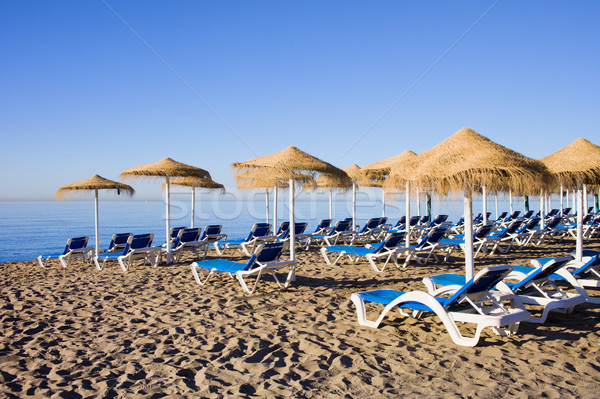 Sun Loungers on Marbella Beach Stock photo © rognar
