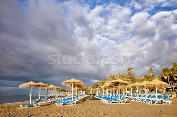 Sun Loungers on Marbella Beach Stock photo © rognar