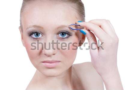 Beautiful young woman plucking eyebrows  Stock photo © rosipro