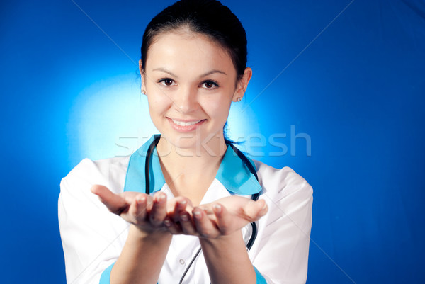 Young smiling woman doctor giving empty space Stock photo © rosipro