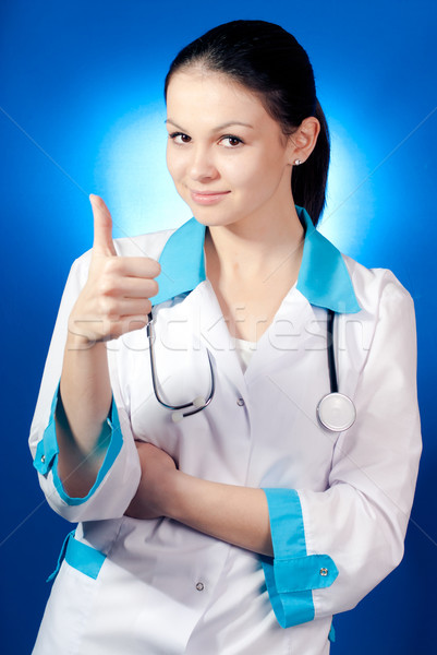 Young smiling woman doctor showing thumb up Stock photo © rosipro