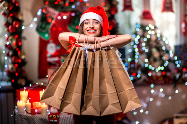 Fiatal nő bevásárlótáskák karácsony díszítések gyertyák ajándékok Stock fotó © RossHelen