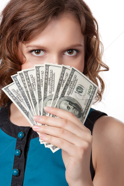 Portrait of pretty young woman holding a fan of dollar bills Stock photo © rozbyshaka