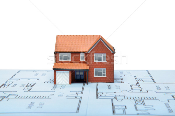 Stock photo: Model house on blueprints