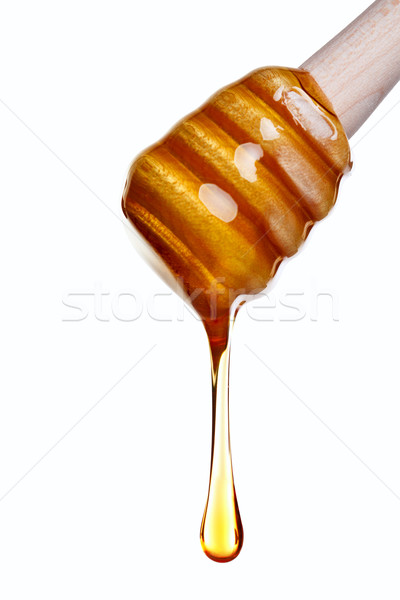 Honey dripping from a wooden dipper Stock photo © RTimages