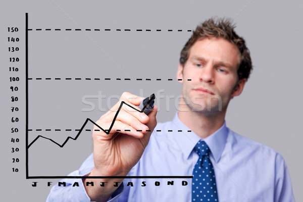 Businessman drawing on glass screen. Stock photo © RTimages