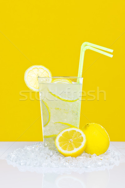 Stock photo: Lemonade in glass yellow background