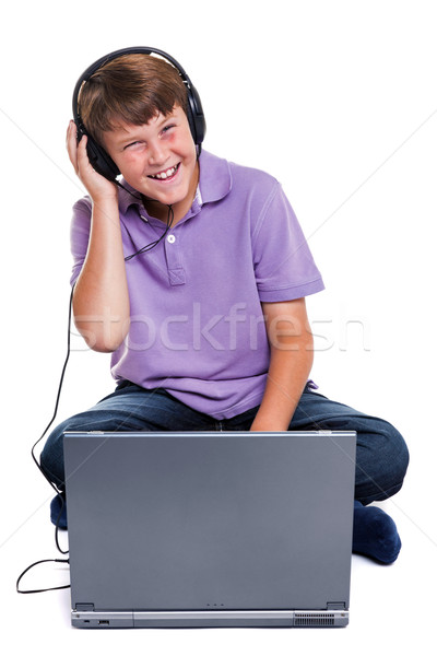 Schoolboy with laptop and headphones isolated Stock photo © RTimages
