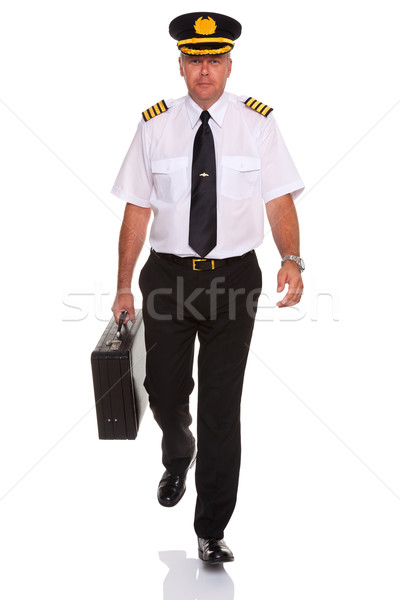 Airline pilot walking carrying flight case. Stock photo © RTimages