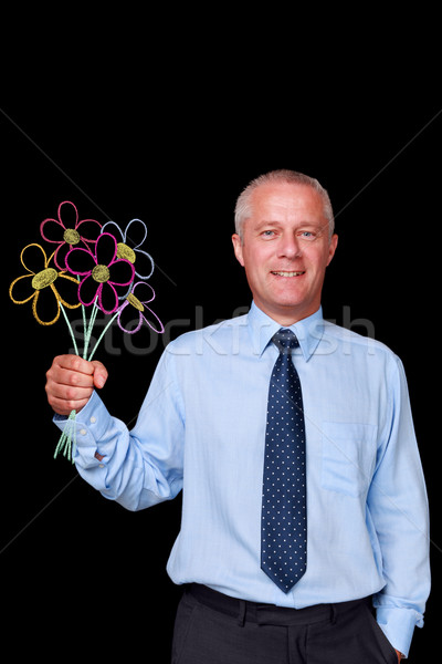 Businessman holding chalk drawn flowers Stock photo © RTimages