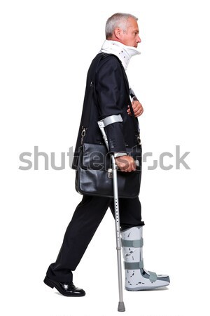 Injred businessman on crutches isolated on white Stock photo © RTimages