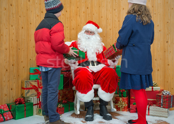 Boy and Girl receiving gifts from Santa Stock photo © RTimages