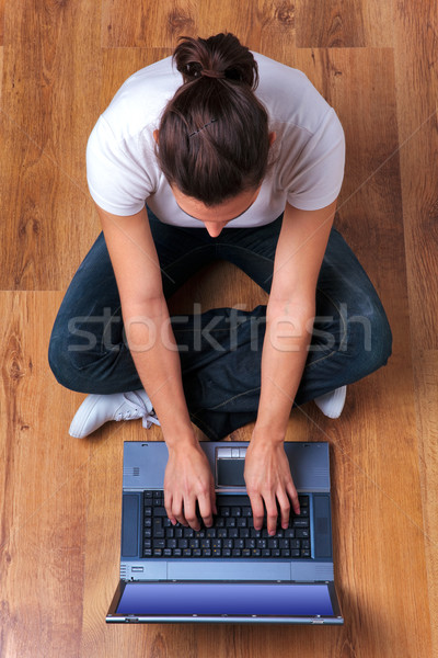 Woman working on laptop overhead Stock photo © RTimages