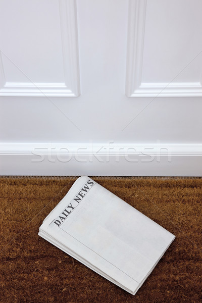 Blank newspaper lying on a doormat. Stock photo © RTimages