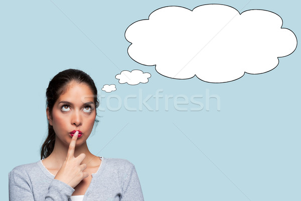 Woman thinking with thought bubbles Stock photo © RTimages
