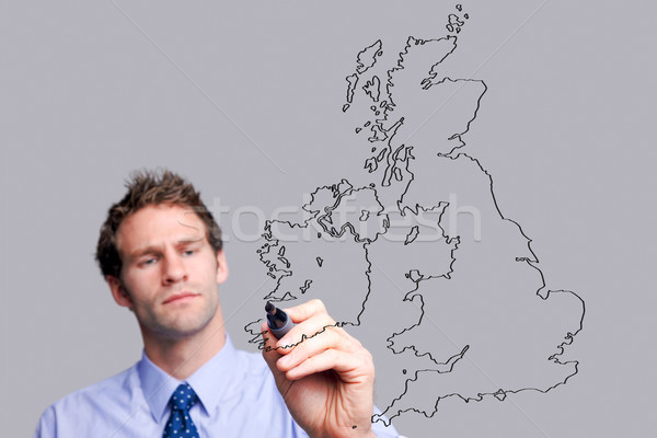 Stock photo: Businessman drawing on glass screen.