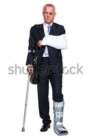 Injred businessman on crutches isolated on white Stock photo © RTimages