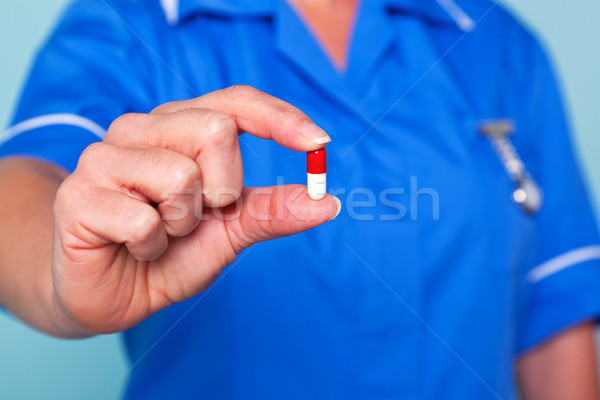 Nurse holding a pill Stock photo © RTimages