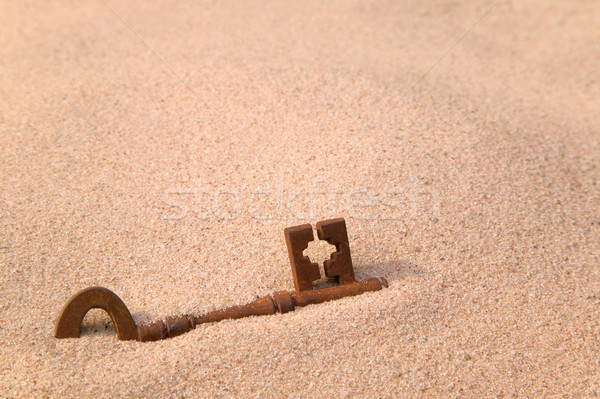 Rusty old key in sand Stock photo © RTimages