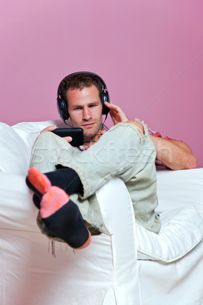 Férfi fotel zenét hallgat visel mp3 lejátszó zene Stock fotó © RTimages