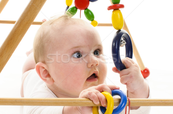 Baby mit Greifspielzeug Stock photo © runzelkorn