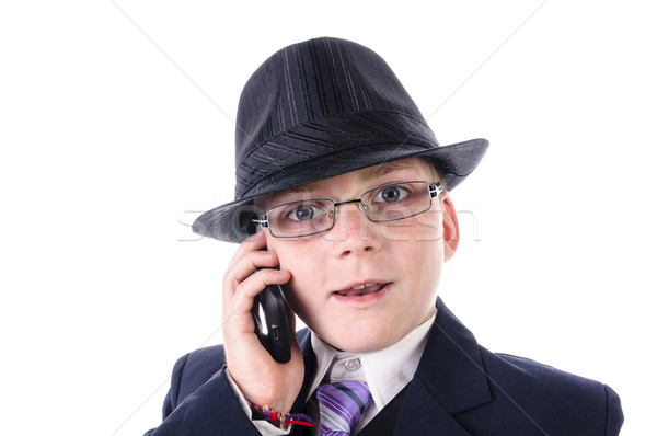 A portrait of a confident little boy in black suit mit telephone Stock photo © runzelkorn