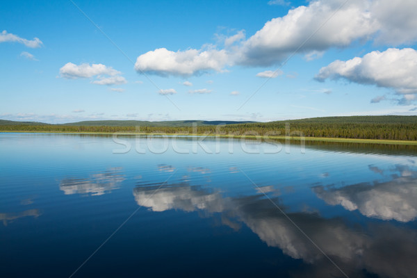 Stock photo: Calm beautiful rural landscape with a lake and sky reflected
