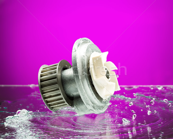 Auto parts, engine cooling pump in spurts of water on purple bac Stock photo © RuslanOmega