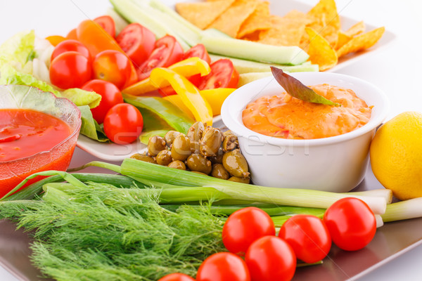 Vegetables, olives, nachos, red and cheese sause Stock photo © ruzanna