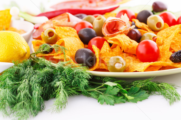 Nachos, olives, pork loin and vegetables Stock photo © ruzanna
