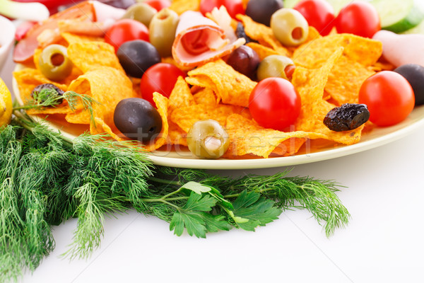 Nachos, olives, pork loin and vegetables Stock photo © ruzanna