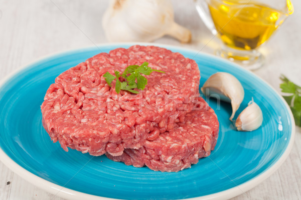 Nyers hamburger friss hús petrezselyem felszolgált Stock fotó © sabinoparente