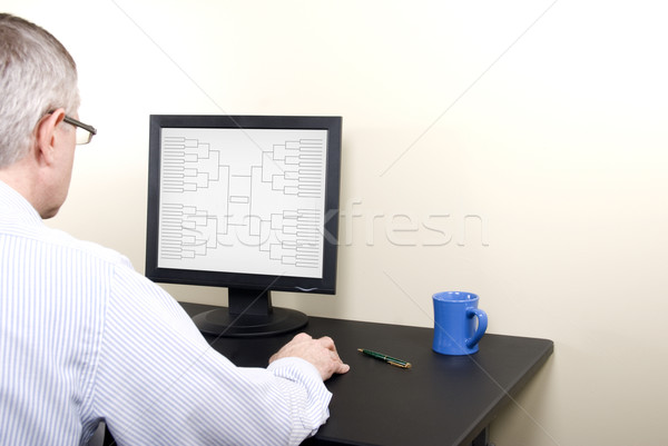 March Madness Man at Computer in Shirt Completing Bracket Stock photo © saje