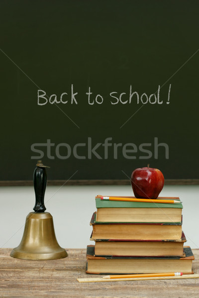 School bell and books on desk with chalkboard Stock photo © Sandralise