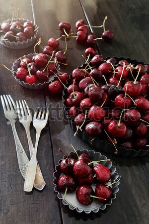 Stock photo: Cherries and flowers on old wood table