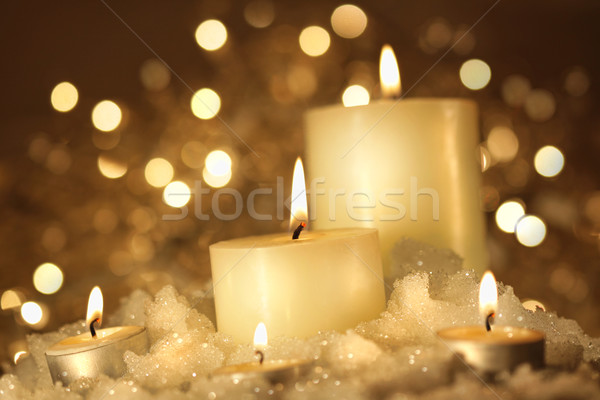 Brightly lit candles in wet snow Stock photo © Sandralise