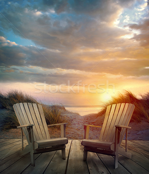 Wooden deck with chairs, sand dunes and ocean Stock photo © Sandralise