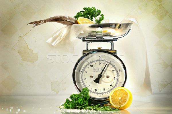 Weight scale with fish and lemons against a grungy, antique back Stock photo © Sandralise