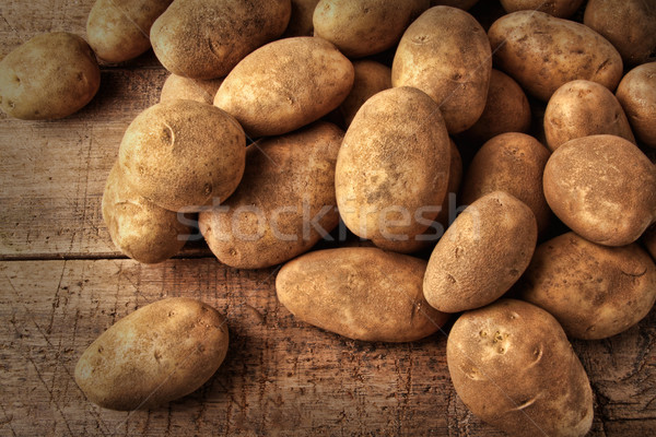 Fresh potatoes on wooden background  Stock photo © Sandralise