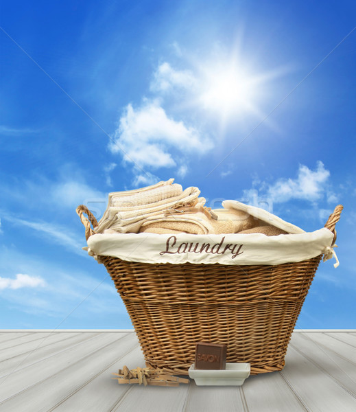 Laundry basket with clothes on rustic table against blue sky Stock photo © Sandralise