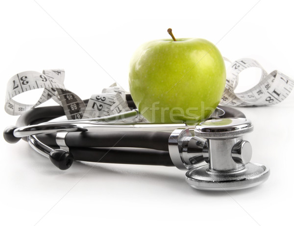 Stock photo: Green apple with stethoscope on white