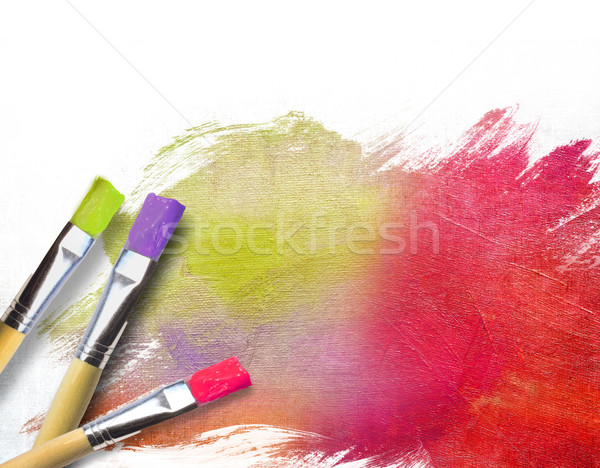 Stock photo: Artist brushes with a half finished painted canvas 