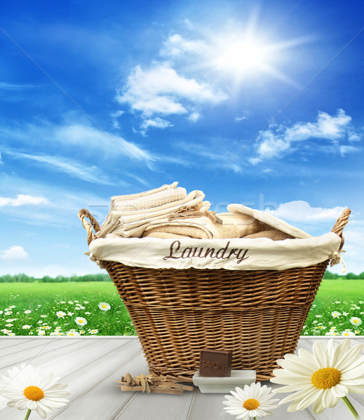 Laundry basket with clothes on rustic table against blue sky Stock photo © Sandralise