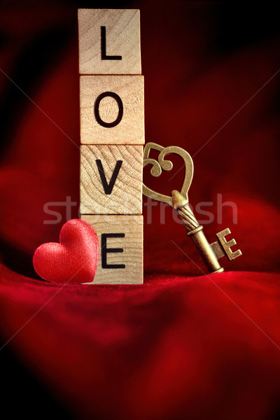 Gold key with wooden block letters that spell the word love Stock photo © Sandralise