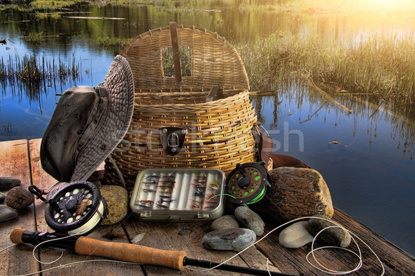Traditional fly-fishing rod with equipment in late afternoon Stock photo © Sandralise