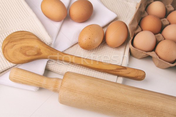 Overhead view of eggs, towels and kitchen tools on table Stock photo © Sandralise