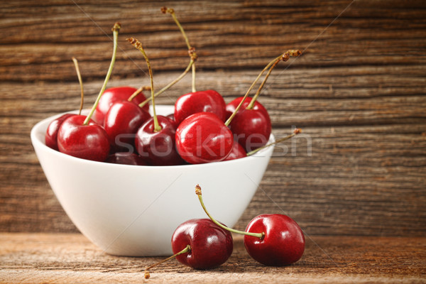Red cherries in bowl on barn wood Stock photo © Sandralise